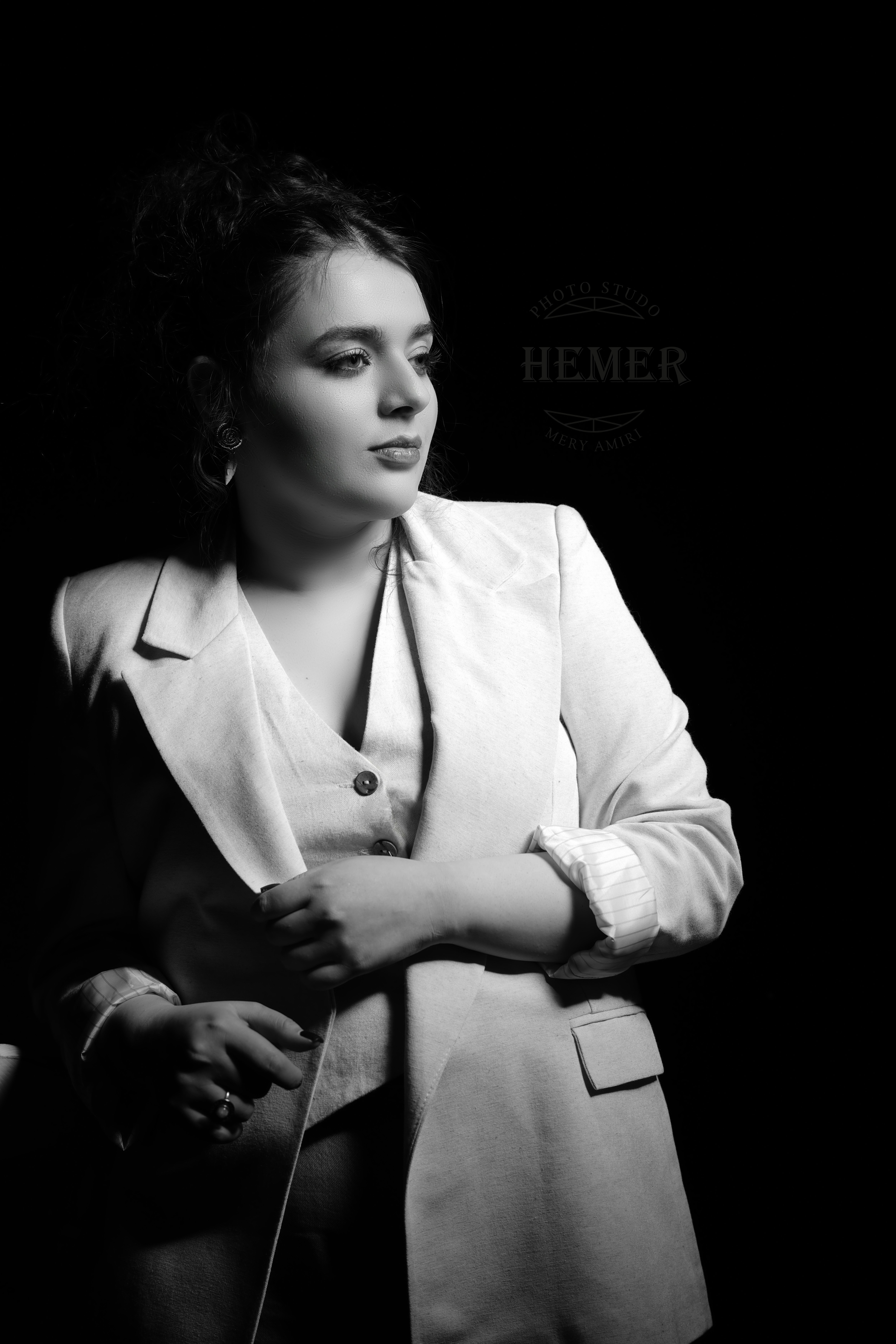 A black and white photo of a woman in a suit